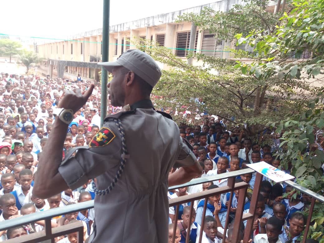 CHAPOL officer addressing a large student crowd from balcony